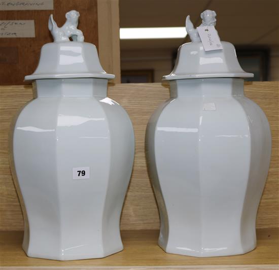 A pair of Chinese style white lidded vases